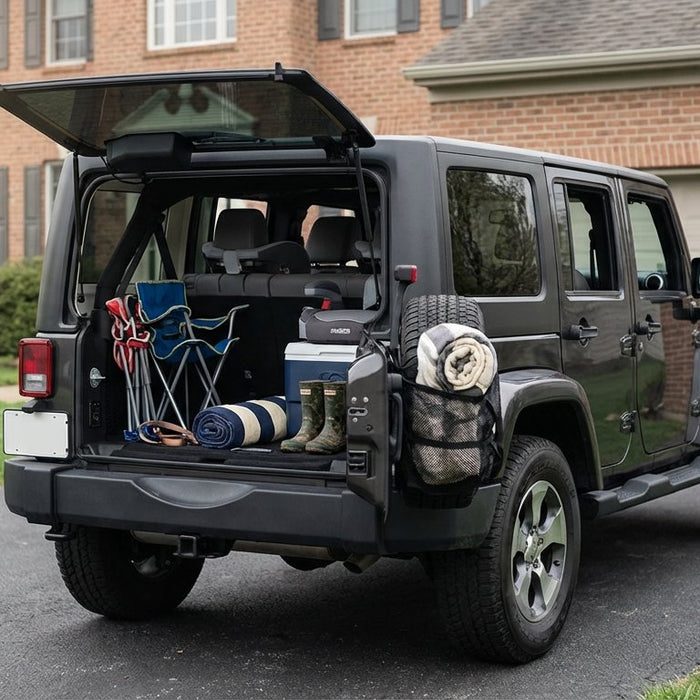 2015 Jeep Wrangler JK Unlimited in Granite Crystal Metallic parked in a suburban family driveway on a Saturday morning, open rear hatch with cooler and kids' gear, charcoal Hothead Headliner visible on the cargo ceiling, booster seats inside