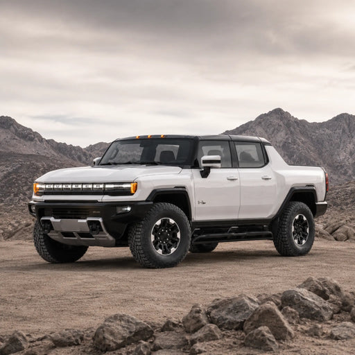 GMC HUMMER EV Pickup facing left in a rocky desert landscape