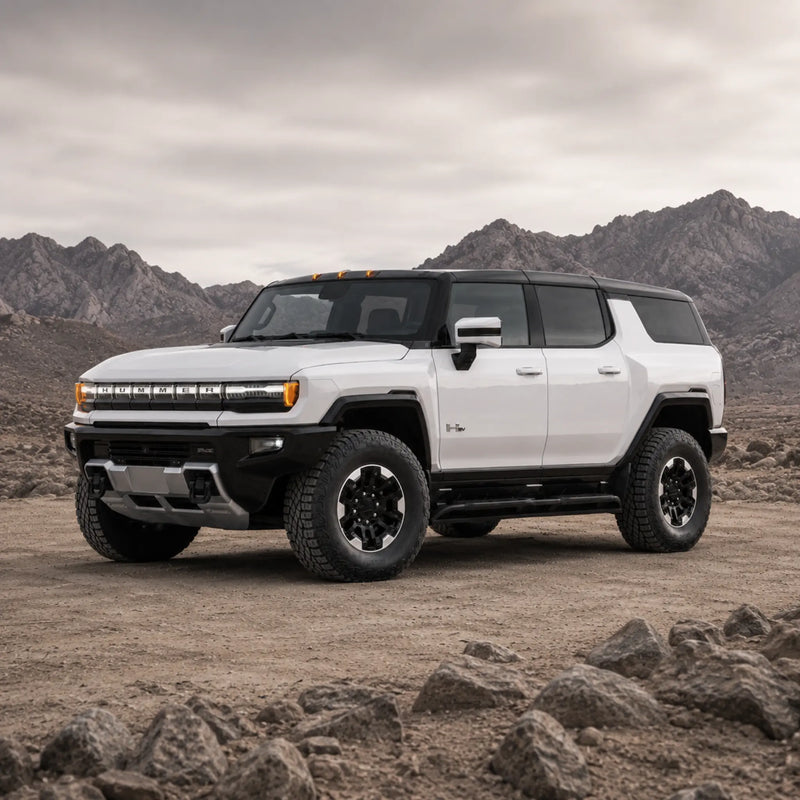 GMC HUMMER EV SUV facing left in a rocky desert landscape
