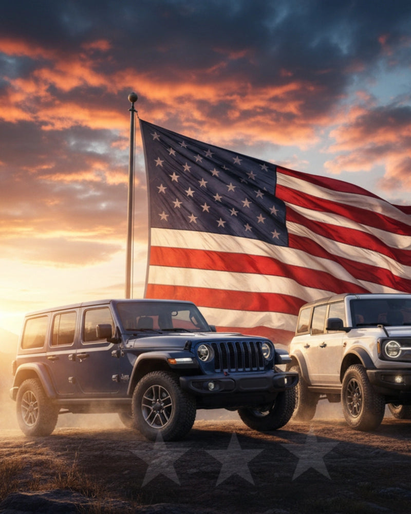 Jeep and Ford Bronco parked before a large American flag at sunset, promoting Hothead Headliners’ Veterans Day Sale with 15% off and free shipping on Jeep and Bronco headliners made in the USA.